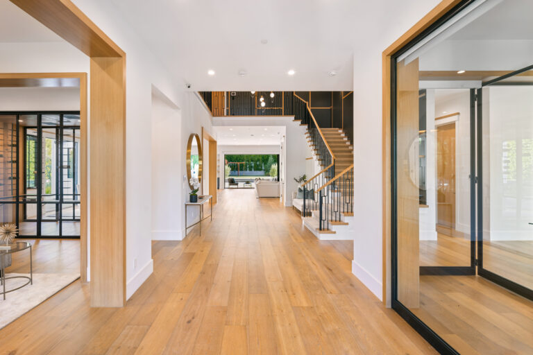 Modern house entryway with hardwood floors and contemporary staircase
